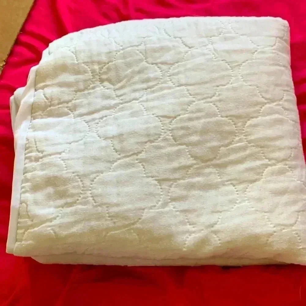 Source unknown  padded crib sheet with rubber backing